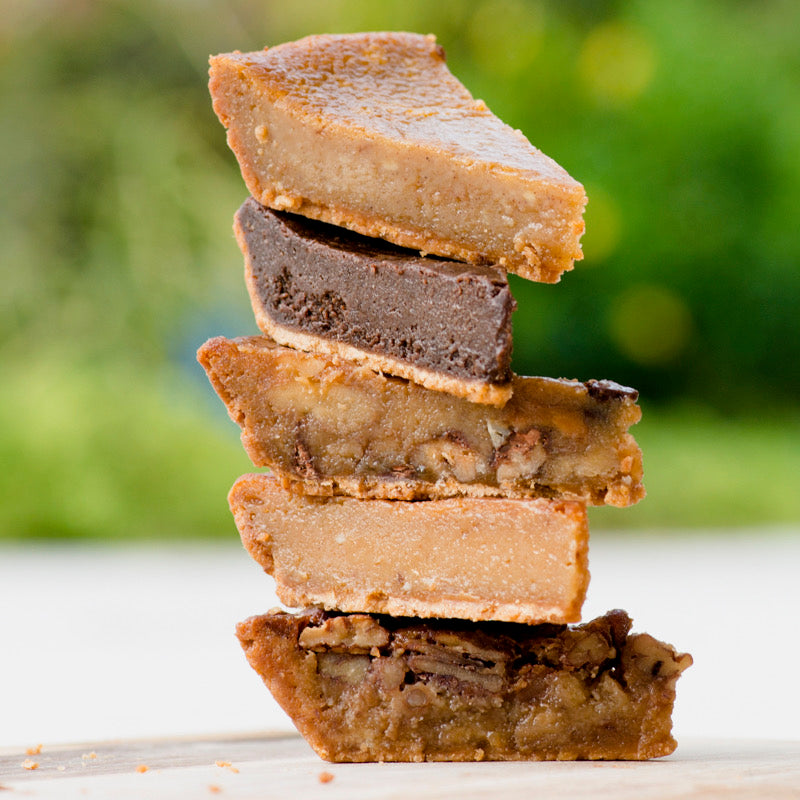 Five flavors of fudge pie stacked outdoors