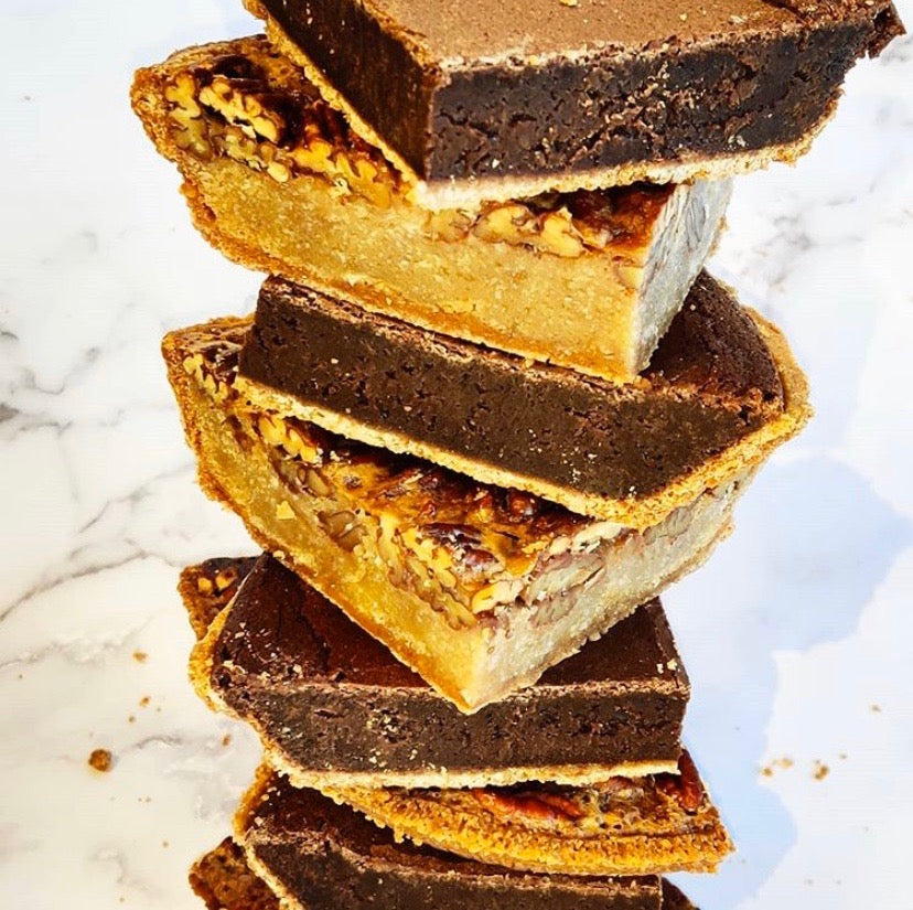 Thick fudge pie slices stacked high on marble